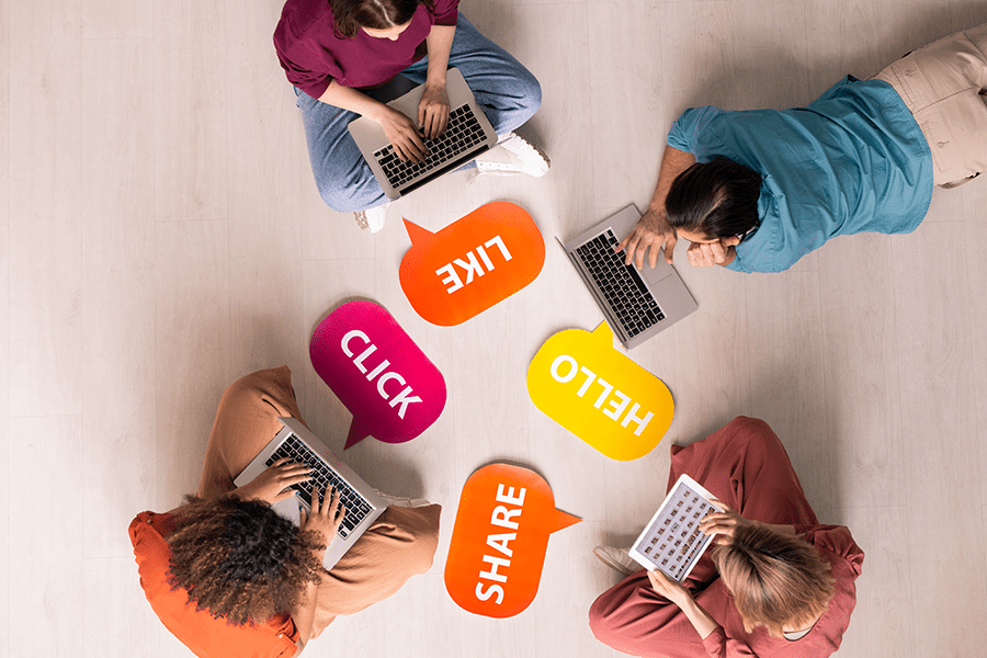 Un cercle de personnes travaillant sur des ordinateurs portables, mettant en œuvre une stratégie marketing pour SocialSnap.